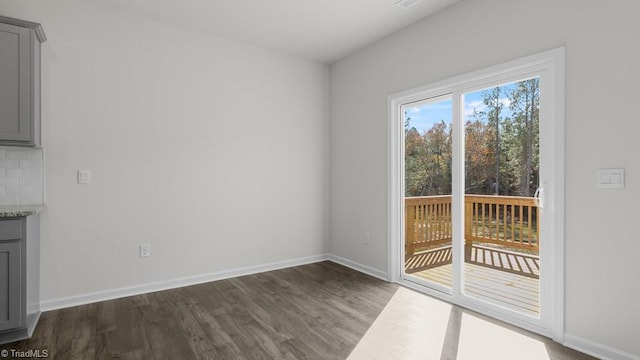 6601 Grogan Hill Rd, Whitsett, NC 27377 - unfurnished dining area with dark wood-style floors and baseboards