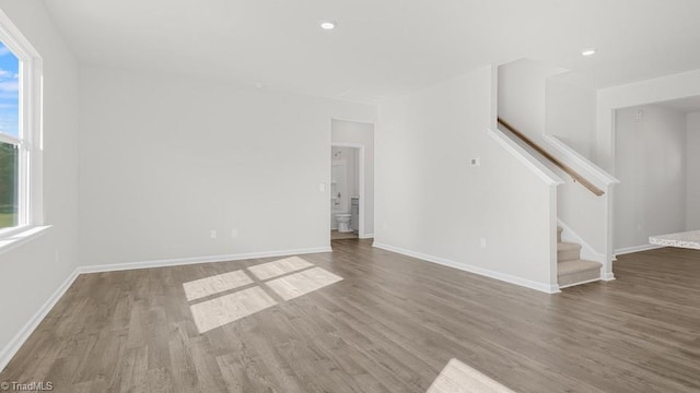 6601 Grogan Hill Rd, Whitsett, NC 27377 - unfurnished living room featuring stairway, wood finished floors, and recessed lighting