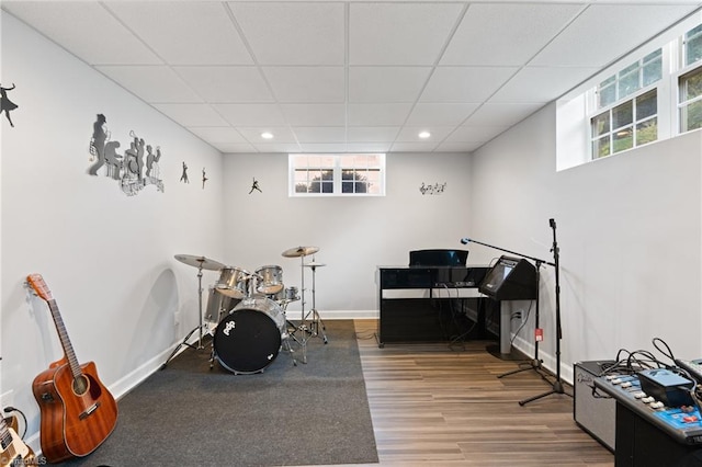 interior space featuring a paneled ceiling and hardwood / wood-style flooring