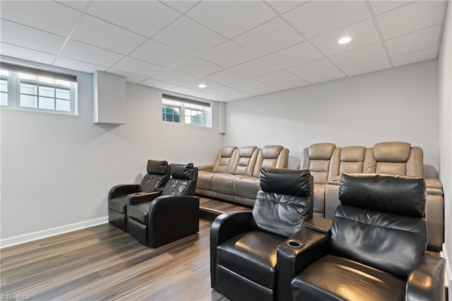 cinema featuring hardwood / wood-style floors and a paneled ceiling