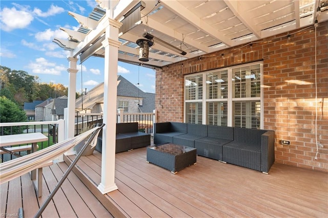 wooden terrace featuring ceiling fan and outdoor lounge area