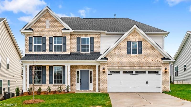 craftsman-style house with a front lawn and a garage