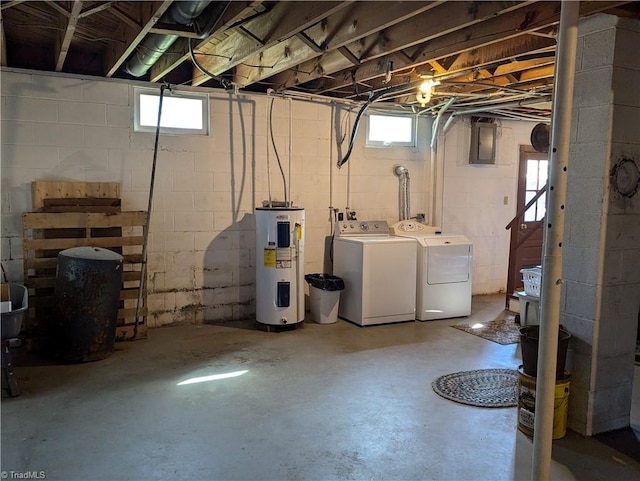 basement featuring water heater, electric panel, a healthy amount of sunlight, and washer and clothes dryer