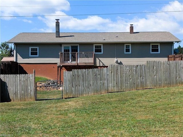 back of property with a deck and a lawn