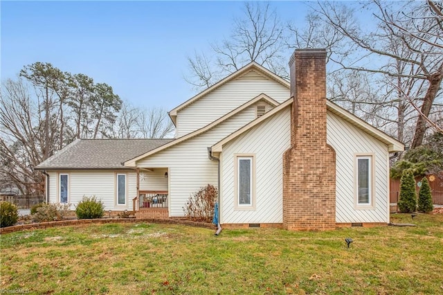 back of house with a lawn