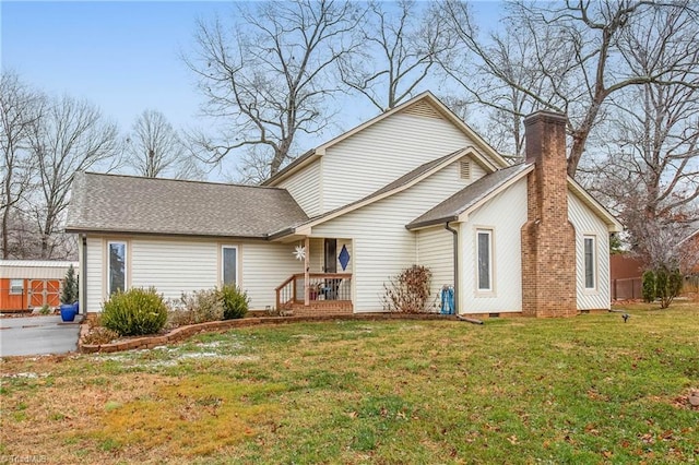 rear view of property with a yard