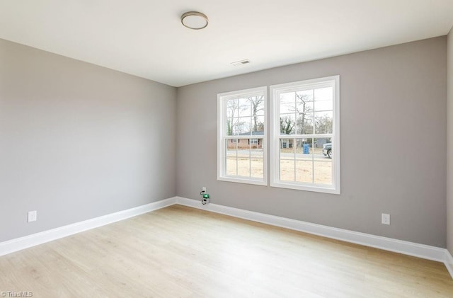 spare room with light hardwood / wood-style floors