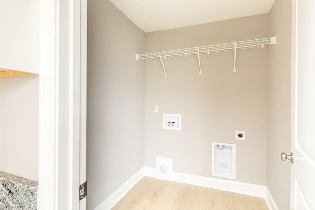 clothes washing area featuring washer hookup, light hardwood / wood-style flooring, and electric dryer hookup