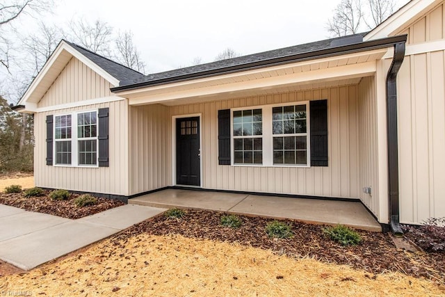 view of exterior entry with a patio area