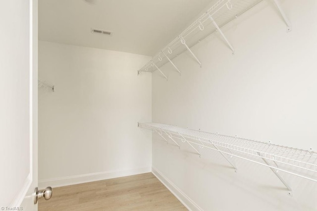 spacious closet featuring hardwood / wood-style flooring