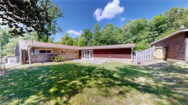 3618 Rockwood Dr, High Point, NC 27265 - back of house featuring fence, a gate, a patio, and a lawn