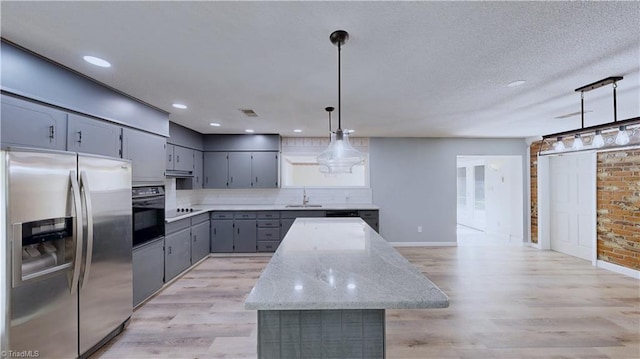 3618 Rockwood Dr, High Point, NC 27265 - kitchen with oven, stainless steel fridge, a sink, gray cabinets, and decorative backsplash
