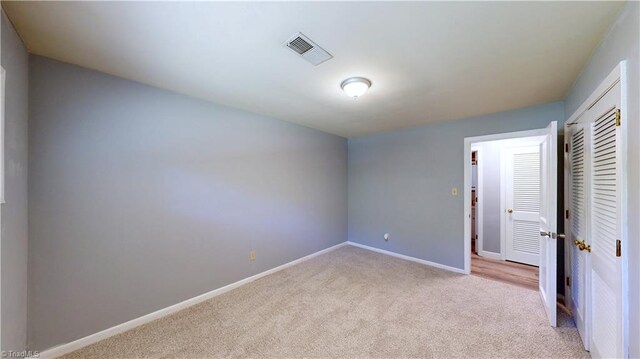 3618 Rockwood Dr, High Point, NC 27265 - unfurnished bedroom with light carpet, baseboards, and a closet