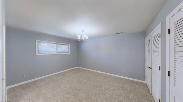 3618 Rockwood Dr, High Point, NC 27265 - unfurnished bedroom with visible vents, carpet, baseboards, and an inviting chandelier