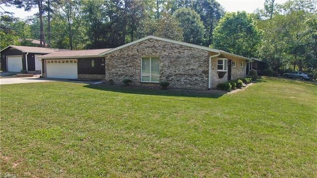 3618 Rockwood Dr, High Point, NC 27265 - ranch-style house featuring a garage, driveway, a front lawn, and brick siding