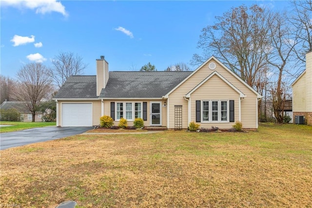 ranch-style home featuring a front lawn, central AC unit, and a garage