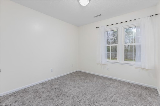 spare room featuring light colored carpet