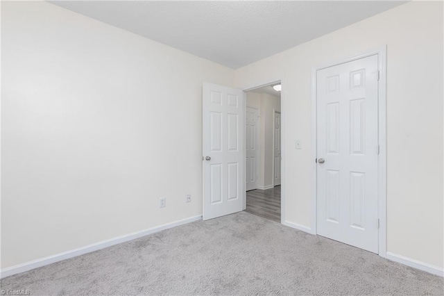 unfurnished bedroom with light colored carpet