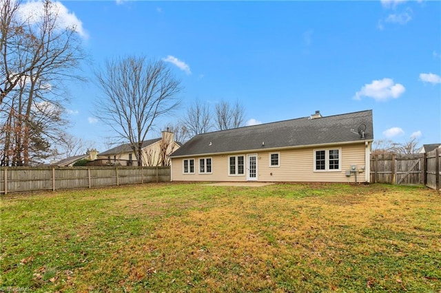 rear view of house with a yard and a patio area