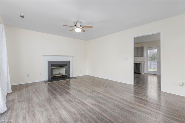 unfurnished living room with ceiling fan and dark hardwood / wood-style floors