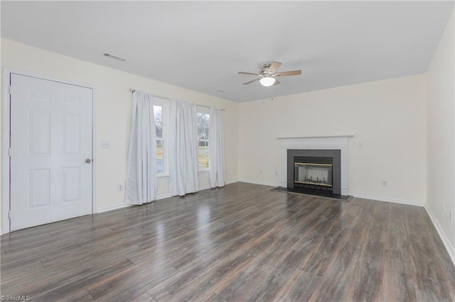 unfurnished living room with dark hardwood / wood-style floors and ceiling fan