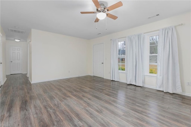 empty room with dark hardwood / wood-style flooring and ceiling fan