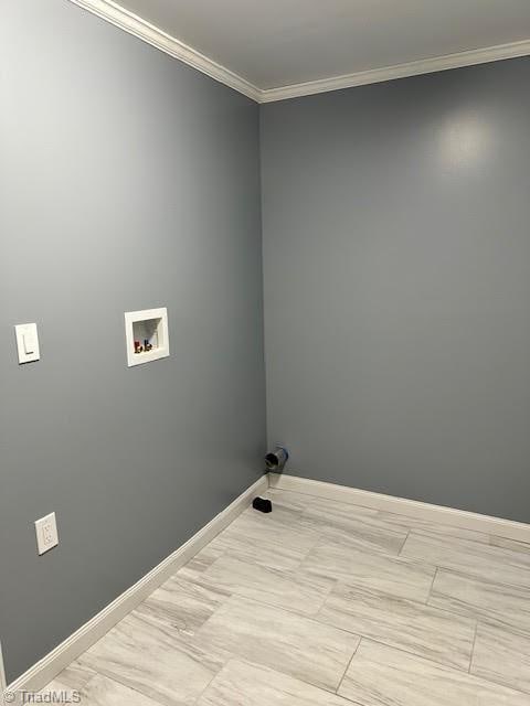 laundry room featuring baseboards, washer hookup, crown molding, and laundry area