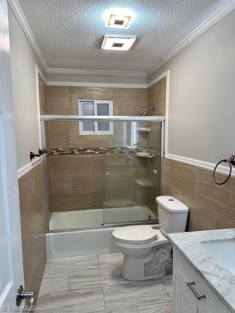 full bathroom with crown molding, a textured ceiling, toilet, and vanity