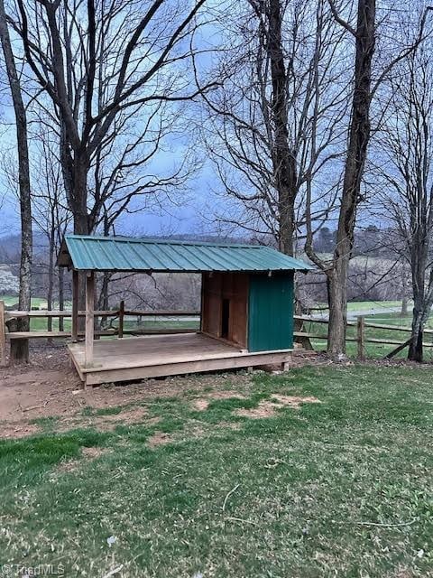 exterior space with an outbuilding and fence