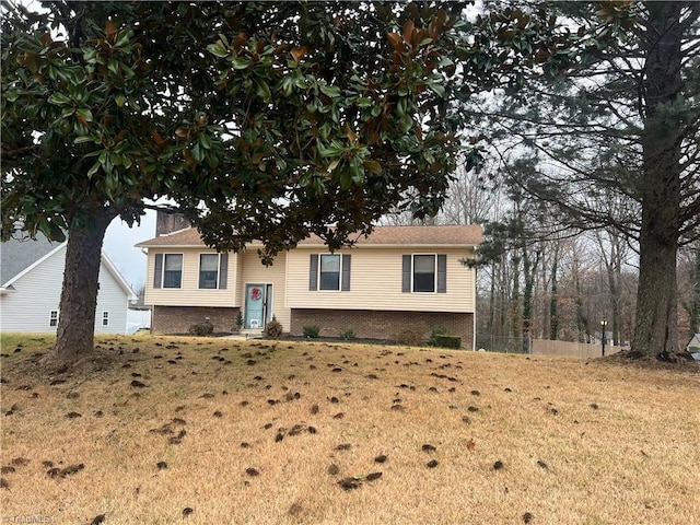 raised ranch featuring a front lawn