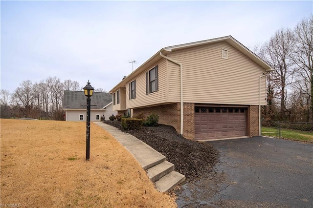 view of home's exterior with a yard and a garage