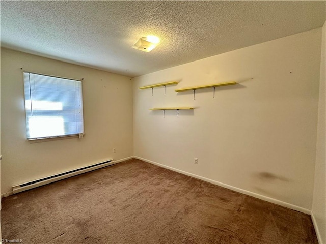 carpeted spare room with baseboard heating and a textured ceiling