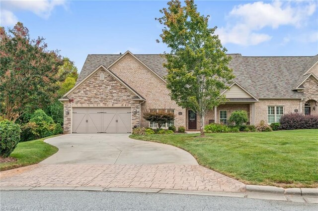 view of front of home with a front yard and a garage