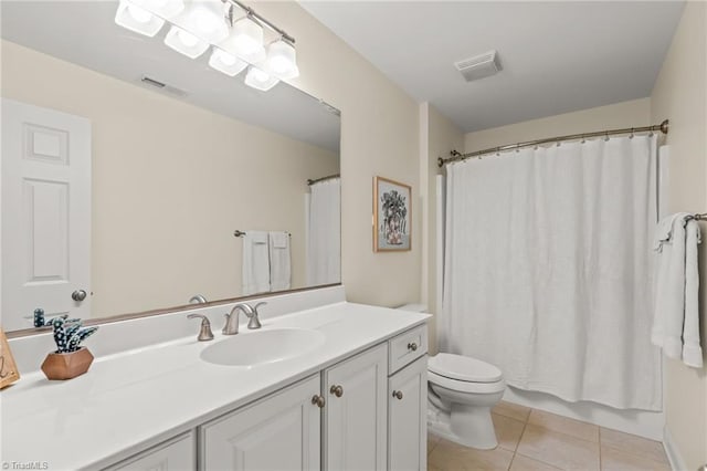 bathroom featuring tile patterned floors, vanity, and toilet