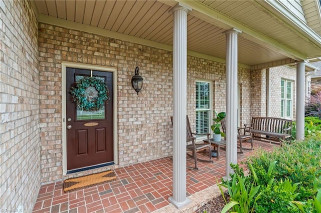 view of exterior entry with a porch