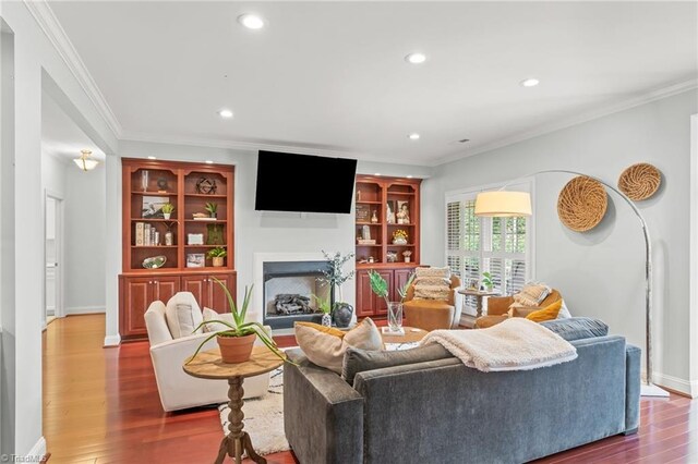 living room with hardwood / wood-style flooring and ornamental molding