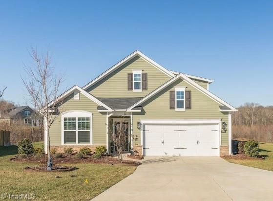 view of front of property with a garage and a front lawn