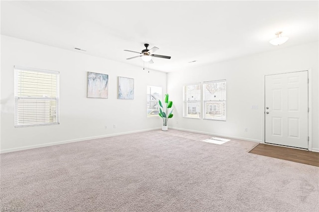 empty room with ceiling fan and carpet