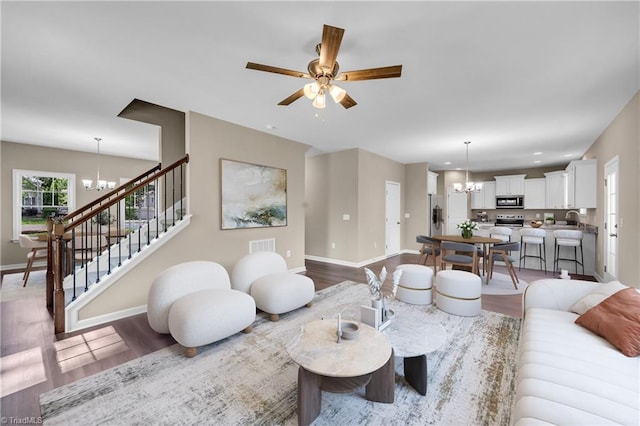 2991 Wesley Farm Ln, Sophia, NC 27350 - living room with a chandelier, wood finished floors, a ceiling fan, and stairway