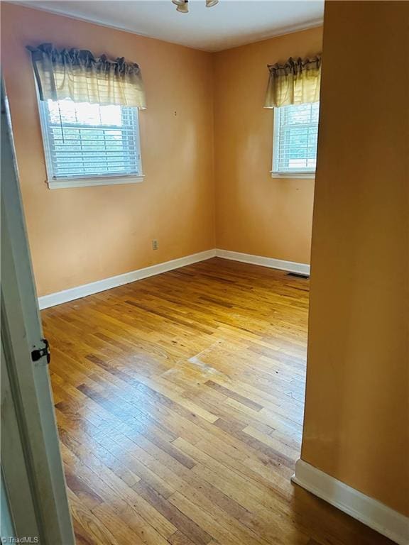 spare room featuring light hardwood / wood-style floors