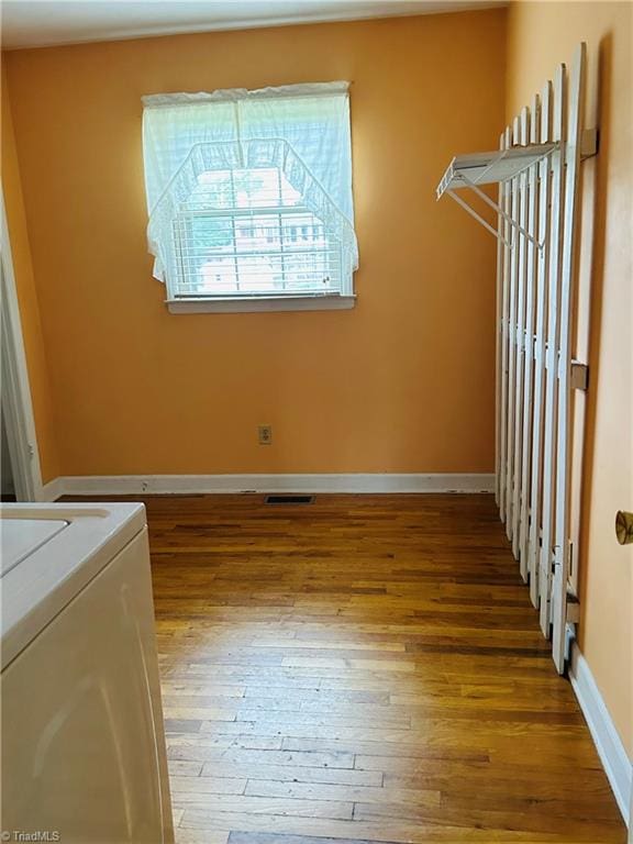 clothes washing area featuring washer / clothes dryer and hardwood / wood-style floors