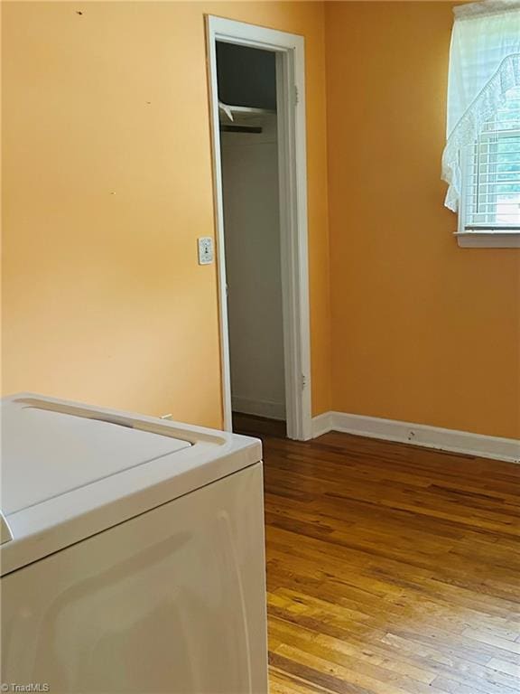 laundry area with washer / dryer and hardwood / wood-style flooring