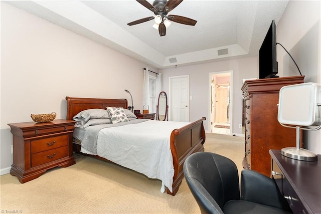 3016 Havasu Way, High Point, NC 27265 - bedroom with light colored carpet, connected bathroom, a raised ceiling, and ceiling fan