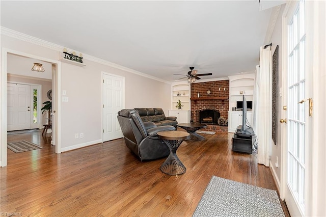 3016 Havasu Way, High Point, NC 27265 - living area with a ceiling fan, plenty of natural light, a fireplace, wood finished floors, and ornamental molding
