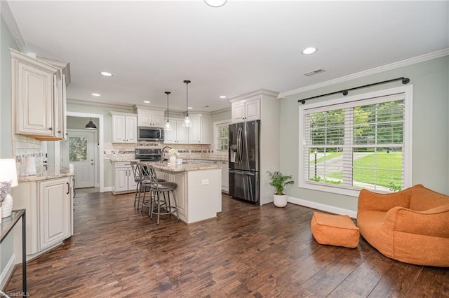 1420 Rankin Rd, Greensboro, NC 27405 - kitchen featuring appliances with stainless steel finishes, ornamental molding, backsplash, dark wood-style flooring, and a kitchen island