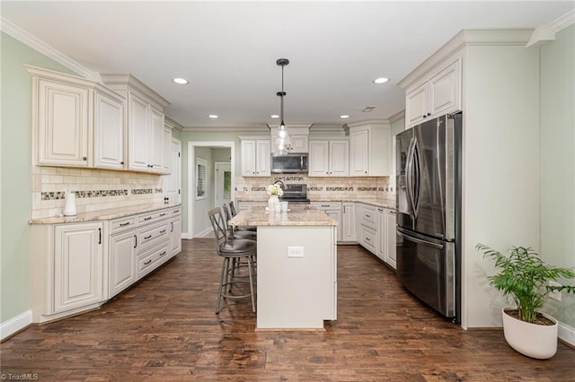 1420 Rankin Rd, Greensboro, NC 27405 - kitchen with stainless steel appliances, decorative backsplash, a breakfast bar, light stone counters, and a center island