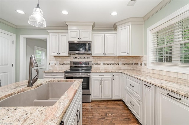1420 Rankin Rd, Greensboro, NC 27405 - kitchen featuring stainless steel appliances, white cabinetry, dark wood-style flooring, decorative light fixtures, and decorative backsplash