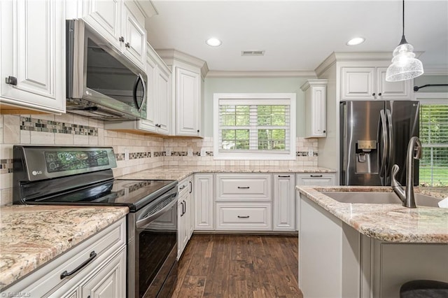 1420 Rankin Rd, Greensboro, NC 27405 - kitchen with stainless steel appliances, dark wood-style floors, white cabinets, light stone counters, and decorative backsplash