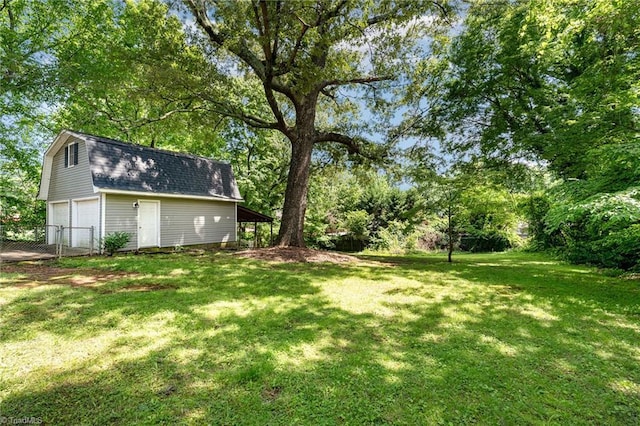 1420 Rankin Rd, Greensboro, NC 27405 - view of yard with view of wooded area, a detached garage, and an outbuilding