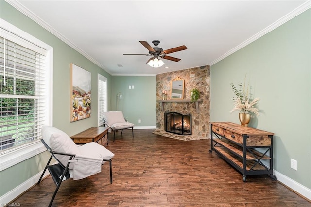 1420 Rankin Rd, Greensboro, NC 27405 - living area featuring wood finished floors, a stone fireplace, ceiling fan, and crown molding